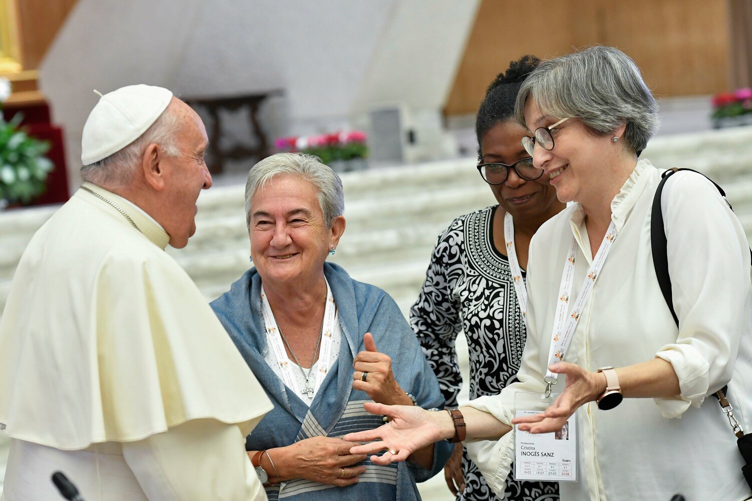 Pope Francis shares a laugh with some of the women members of the assembly of the Synod of Bishops, including Spanish theologian Cristina Inogés Sanz, left, at the assembly’s session Oct. 6, in the Paul VI Audience Hall at the Vatican.